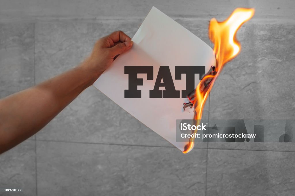 Burn fat text on burning paper in the hand